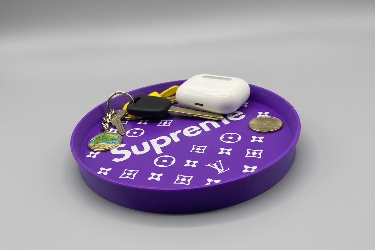 Purple mouse pad with 'Supreme' branding and keys on a dark surface