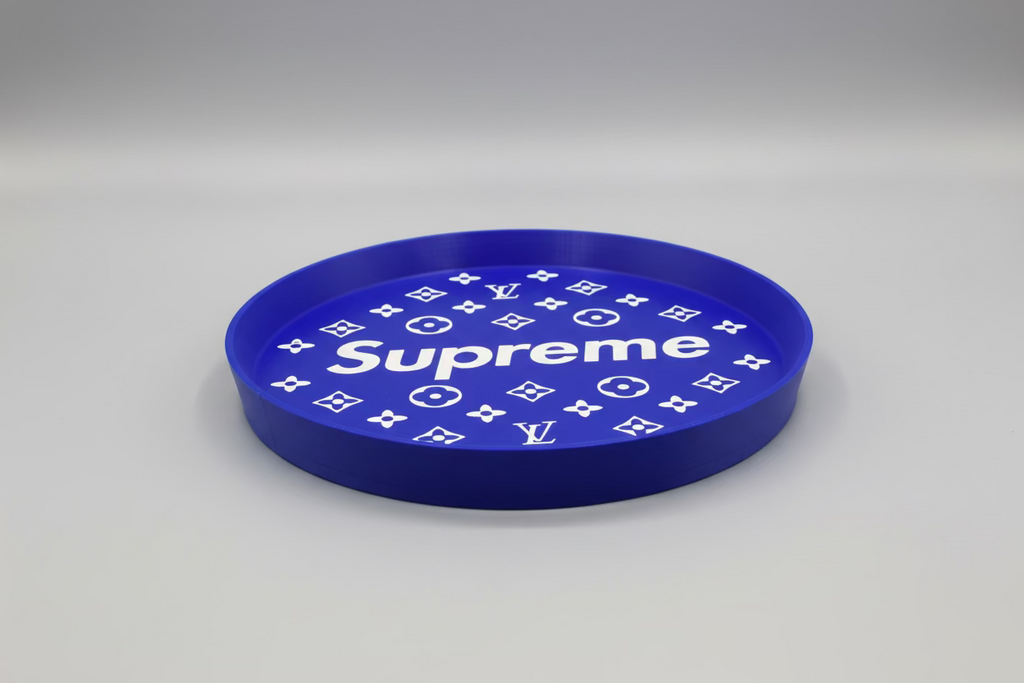 Blue circular object with 'Supreme' and Louis Vuitton logos on a dark background