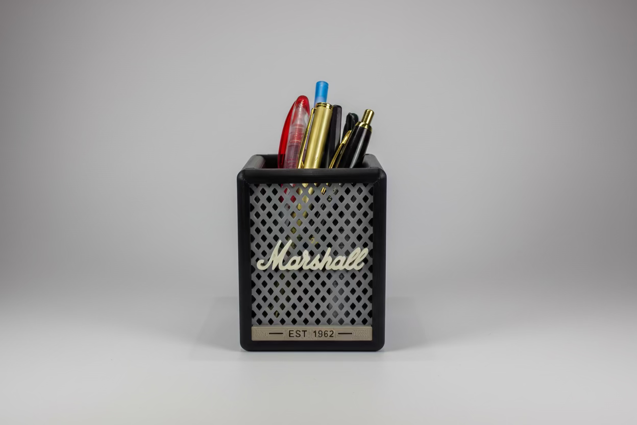 Marshall branded pen holder with pens on a white surface