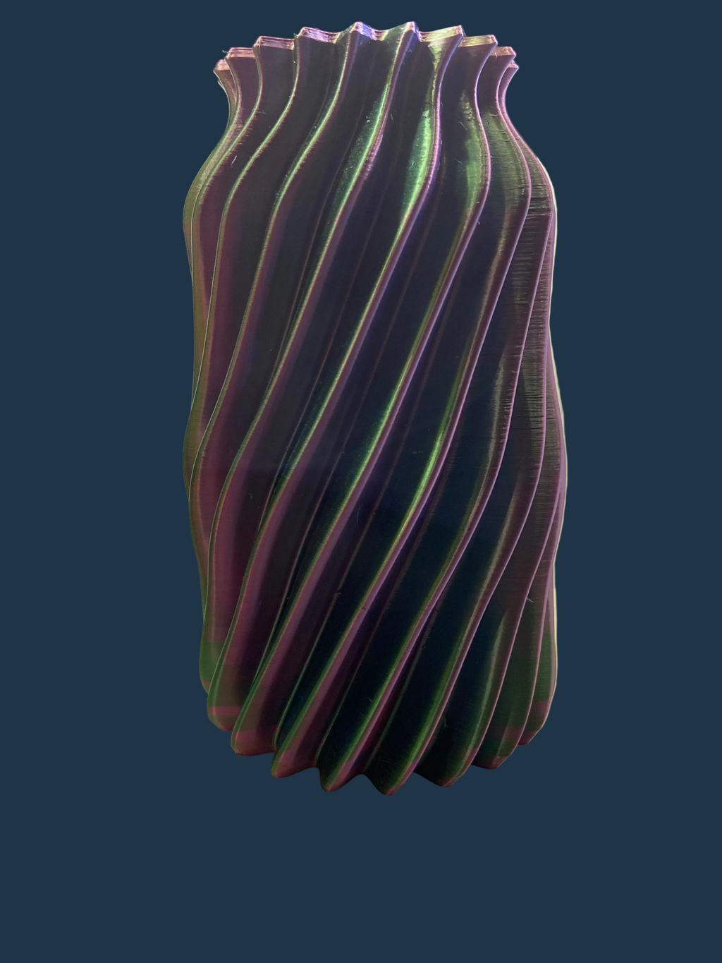 Decorative vase with wavy design on a white surface