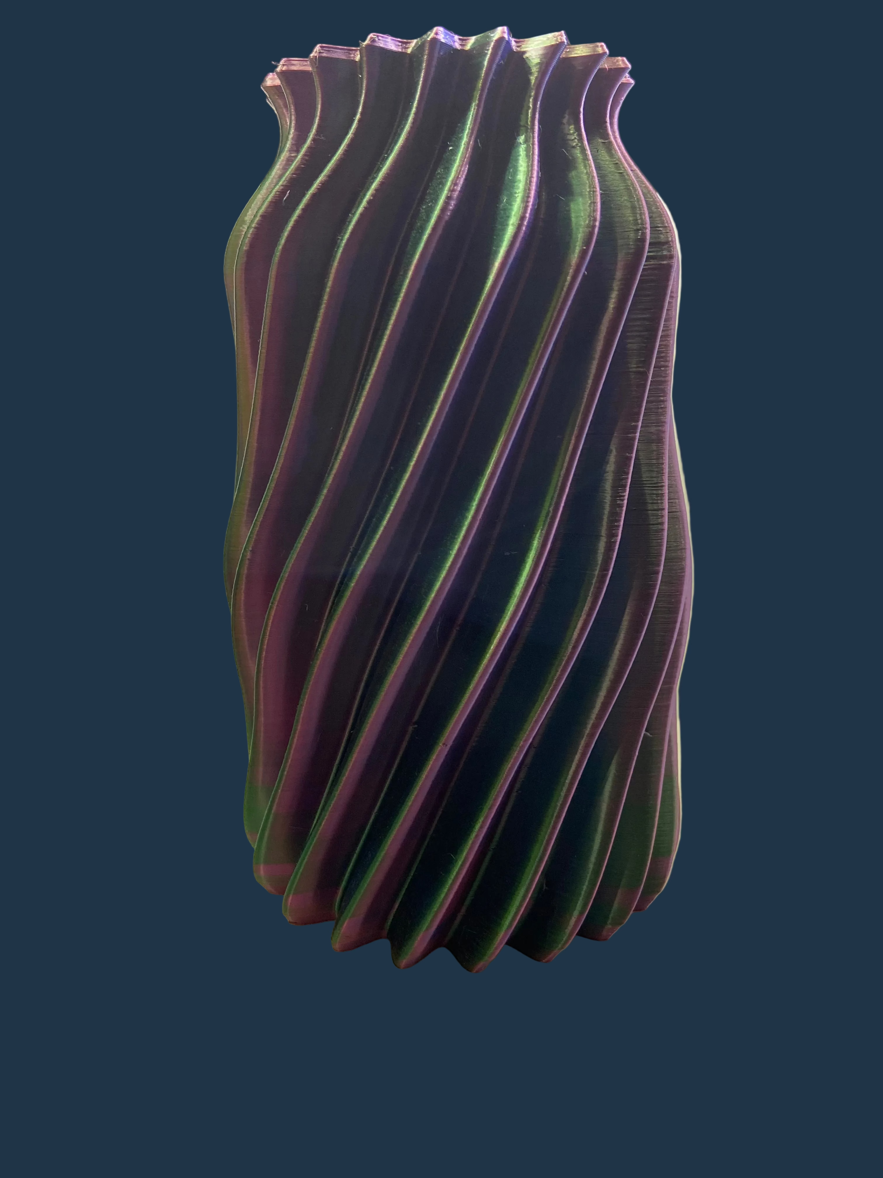 Decorative vase with wavy design on a white surface