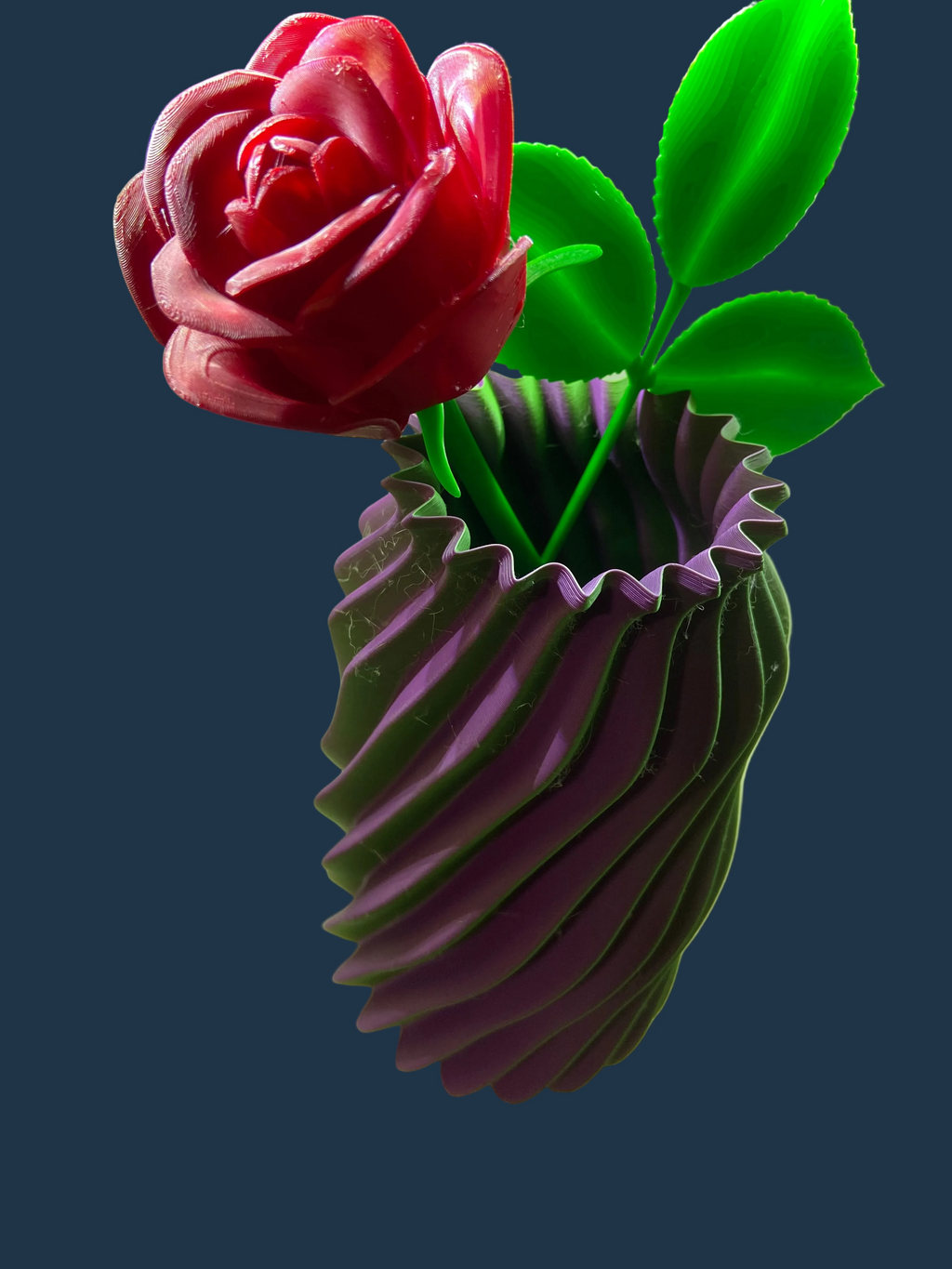 3D-printed purple vase with a red rose and green leaves on a white surface.