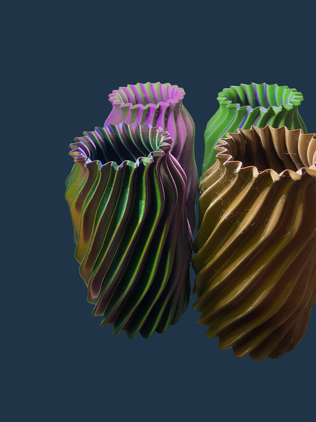 Three 3D-printed models on a white surface with a blurred background