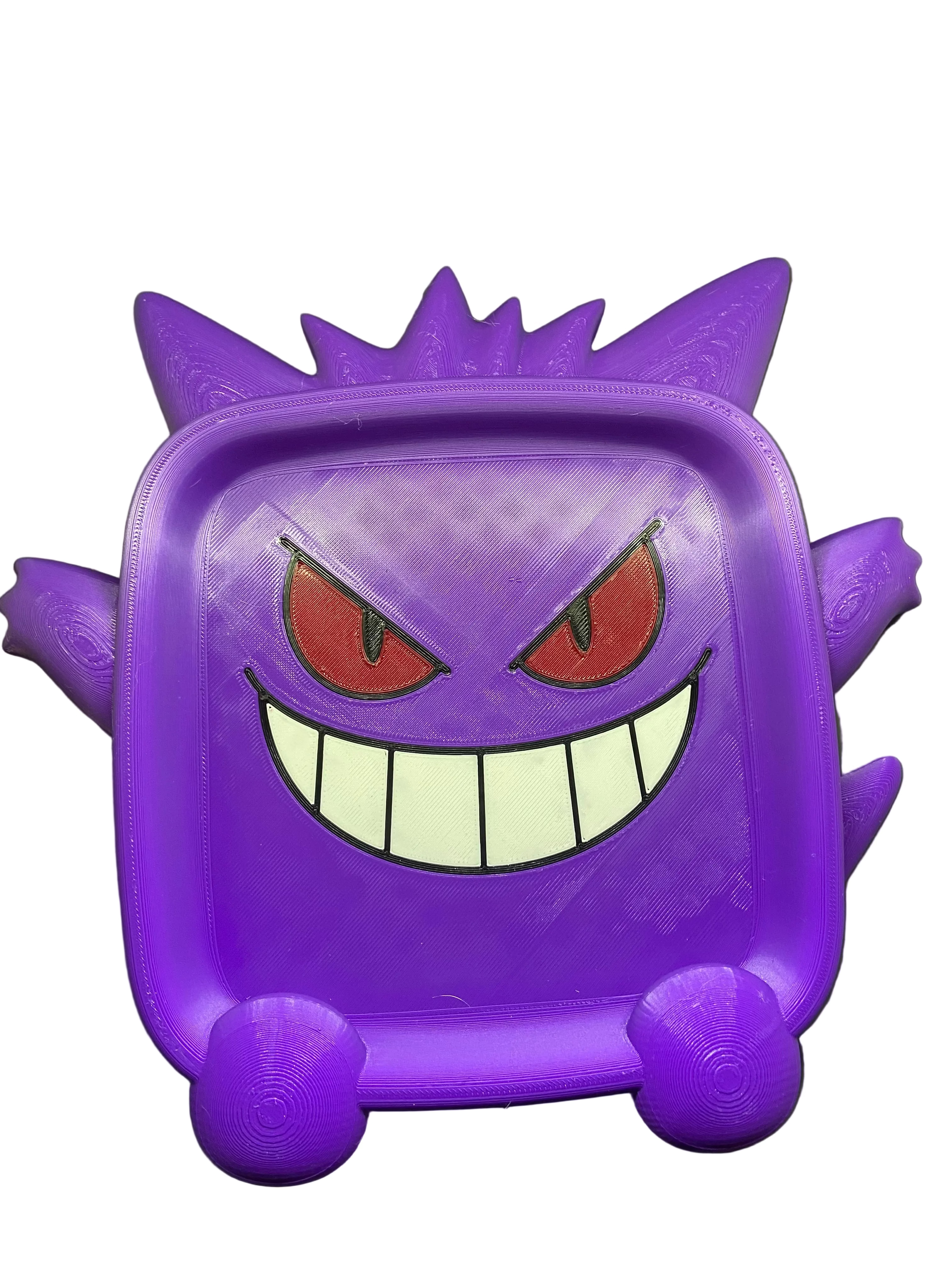 Purple cartoon character with red eyes and a wide grin on a gray surface