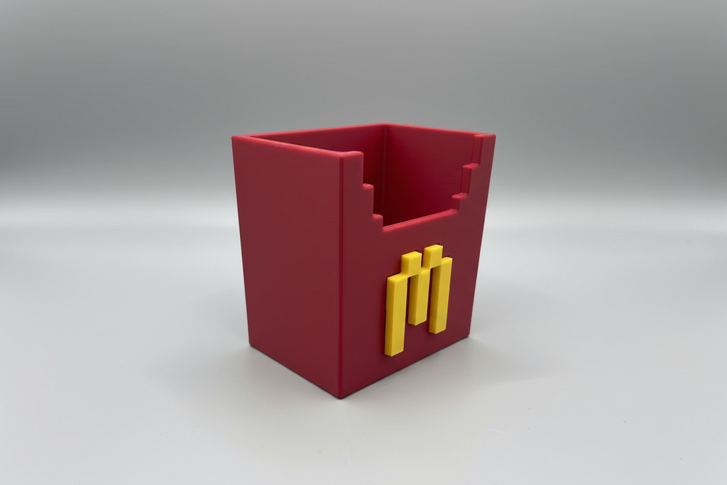Pink container with yellow sticks on a gray surface