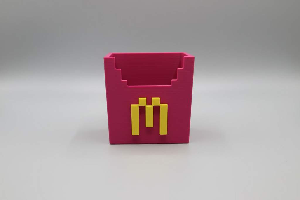 Purple geometric container with gold accents on a reflective surface
