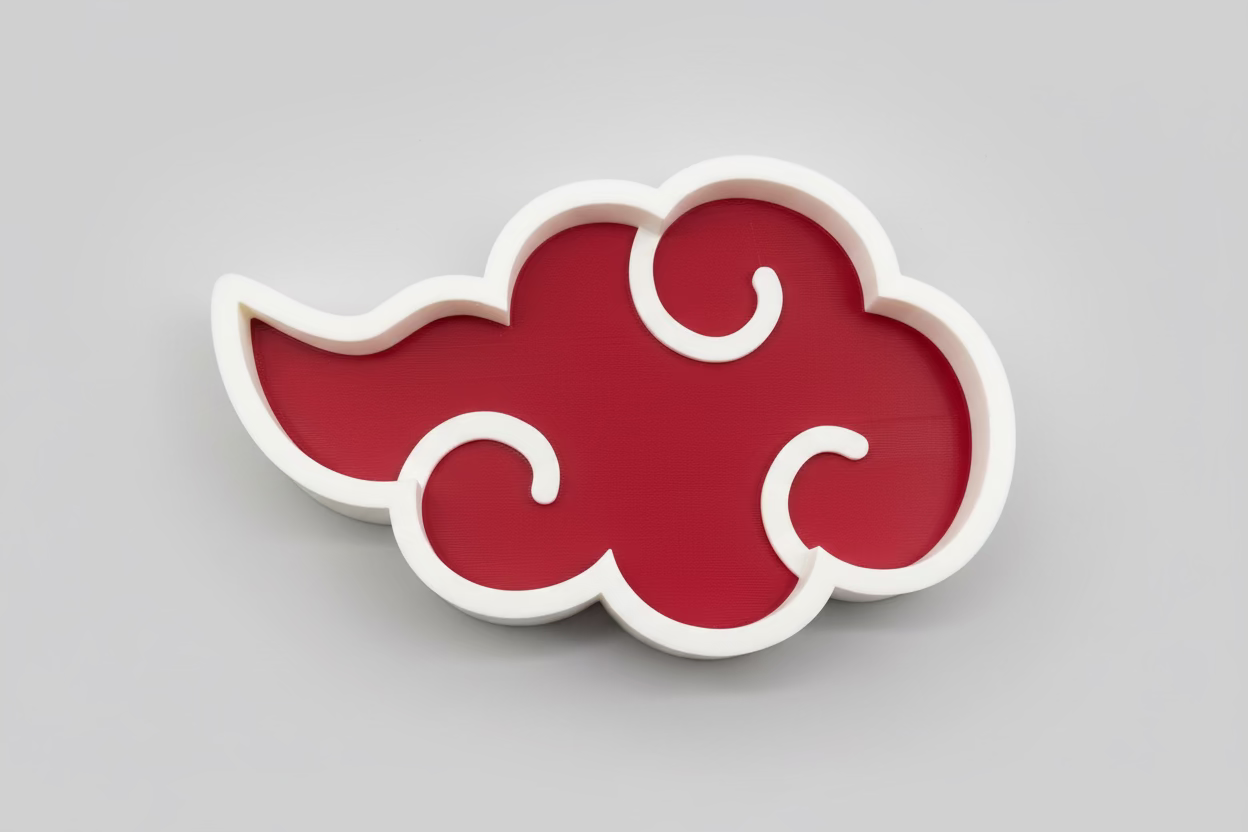 Red cloud-shaped object with white edges on a black background