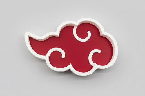 Red cloud-shaped object with white edges on a black background