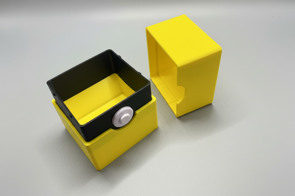 Yellow and black rectangular device on a gray surface